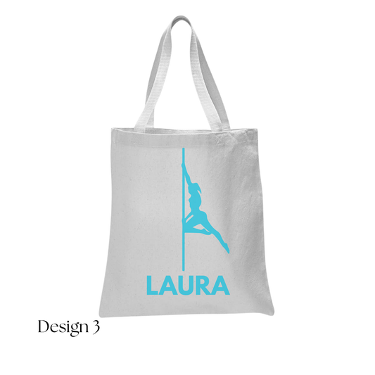 White tote bag with blue graphic and 'LAURA' text on a white background